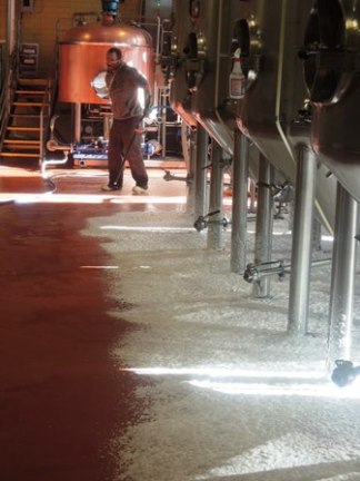 The most action in the brewery was this man spraying foam under the tanks.